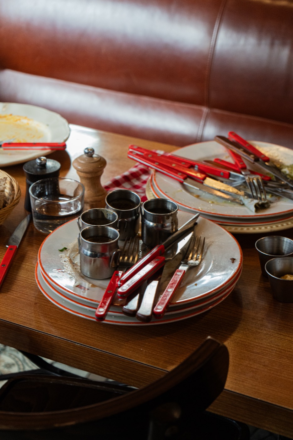 Table dressée avec assiettes et couverts à manche rouge